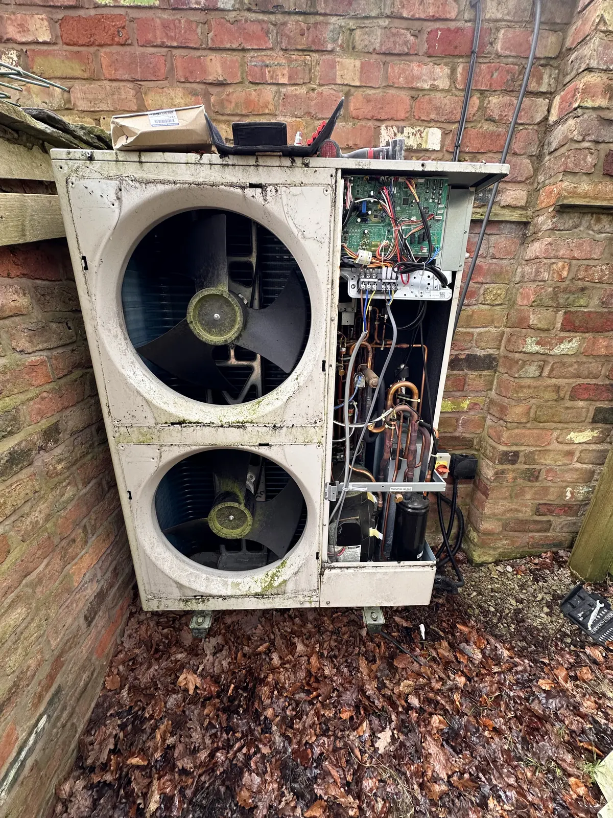 Air source heat pump outdoor unit with the front cover off on a service visit