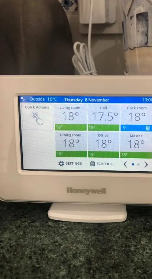Honeywell evohome touchscreen showing room temperatures and schedules